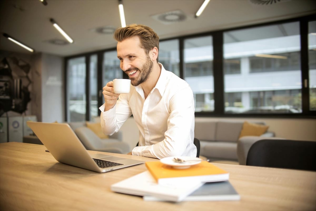 A happy employee with his cup of office coffee