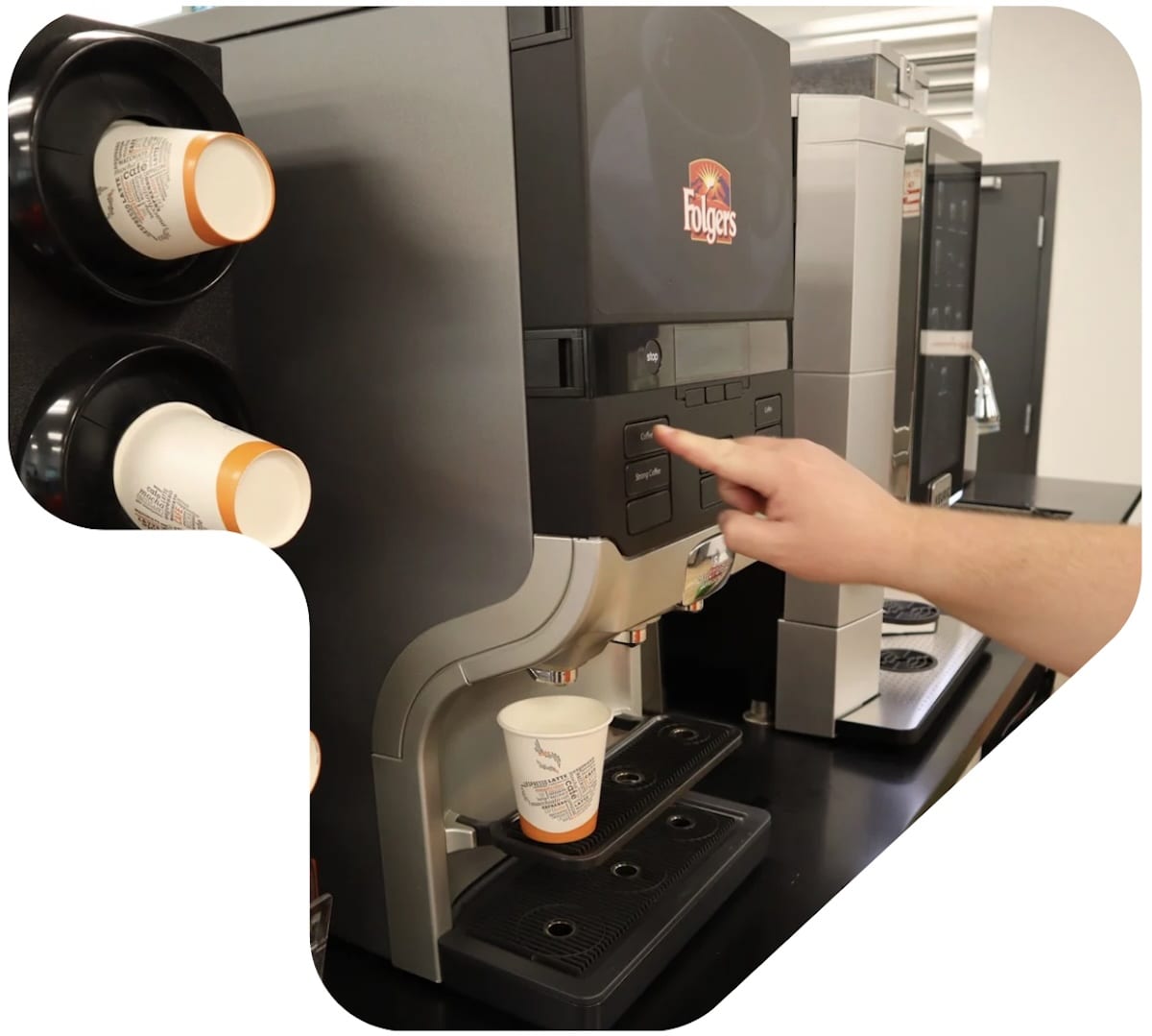 A barista operating a cafe-style coffee maker